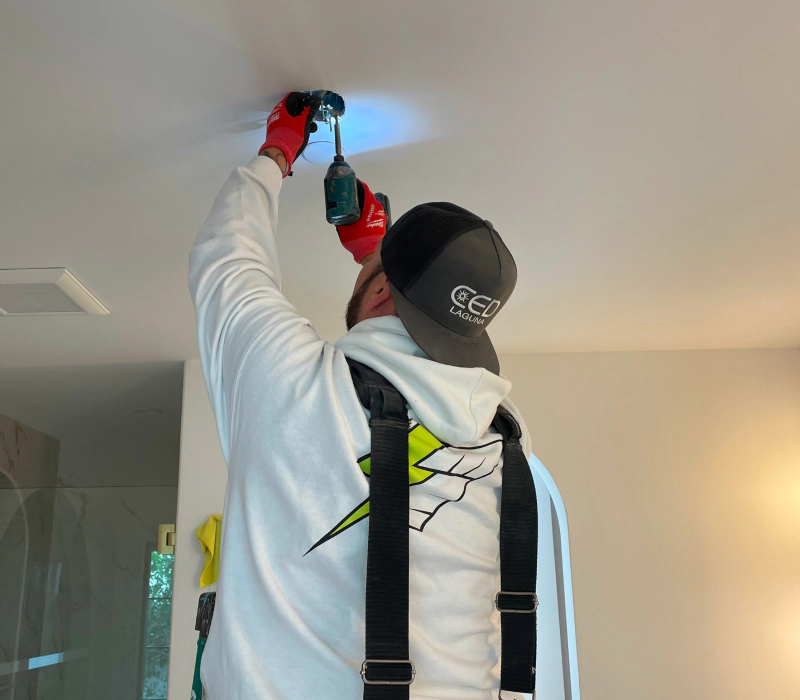 man fixing electrical light outlet